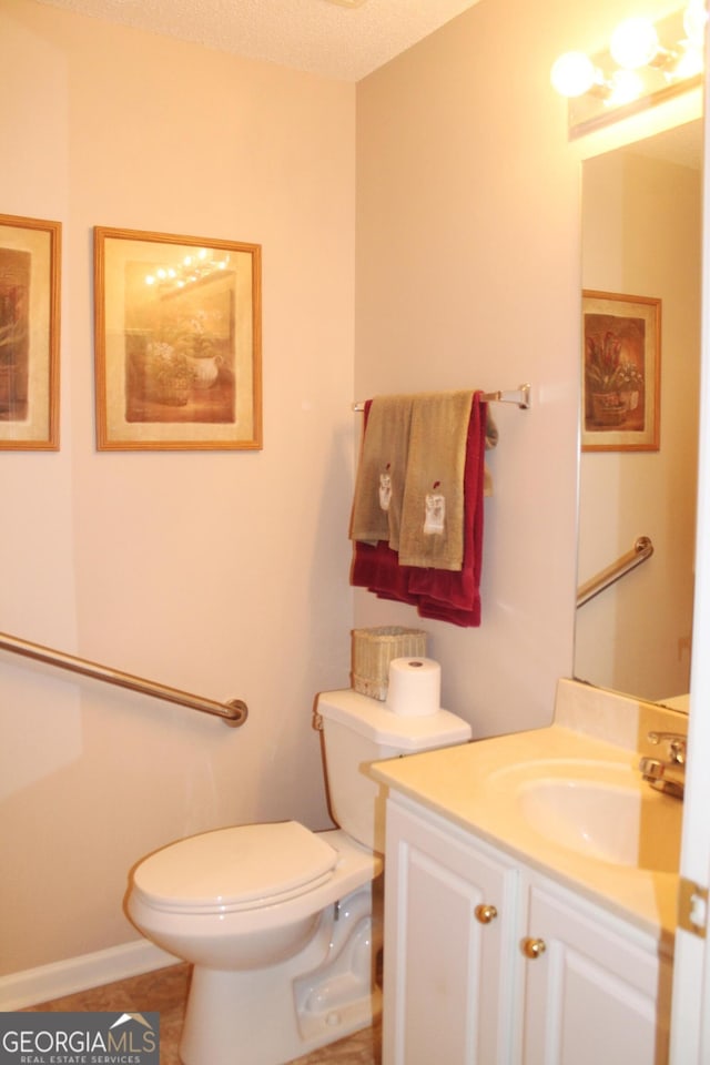 bathroom with toilet and vanity