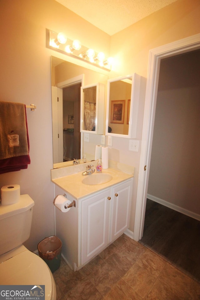 bathroom featuring toilet and vanity