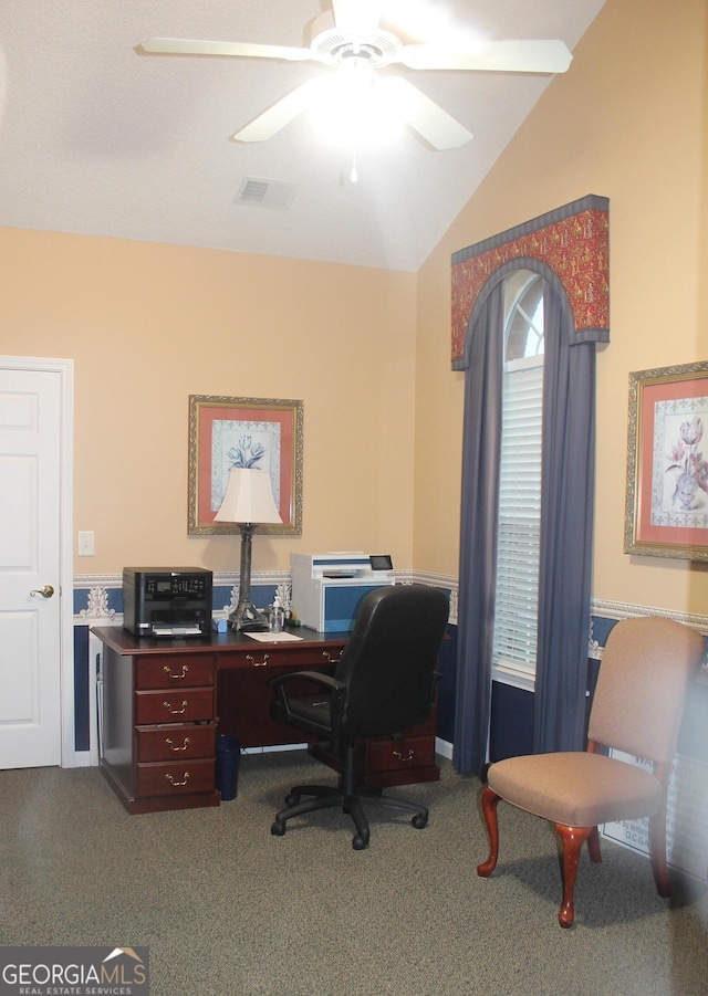 home office with dark carpet, ceiling fan, and lofted ceiling