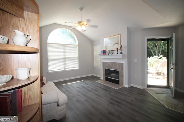 3024 Orchard Ridge Cir, Duluth, GA 30096 - living room with vaulted ceiling, plenty of natural light, a ceiling fan, wood finished floors, and a tile fireplace