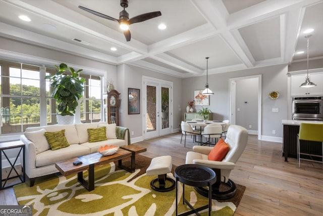 living room featuring baseboards, light wood-type flooring, coffered ceiling, ceiling fan, and beam ceiling