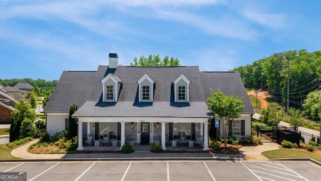 view of property with uncovered parking and fence