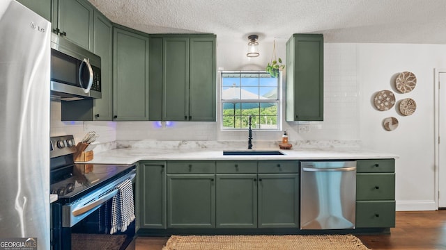 254 Merilyn Dr, Ringgold, GA 30736 - kitchen with green cabinets, appliances with stainless steel finishes, and a textured ceiling