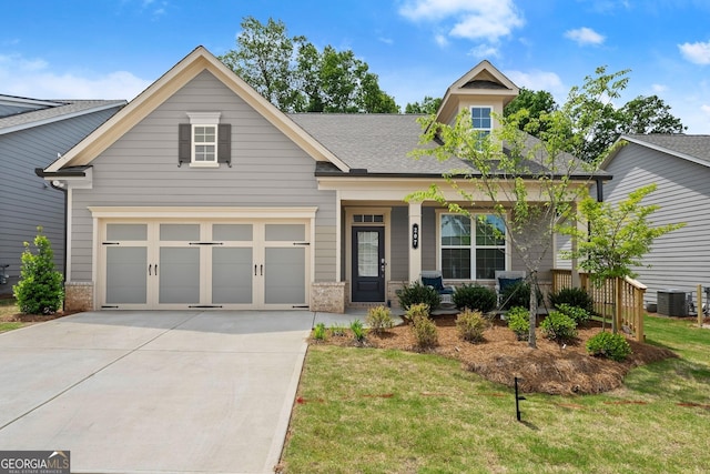 207 Hickory Bluffs Pkwy, Canton, GA 30114 - craftsman house featuring concrete driveway, a front yard, brick siding, and cooling unit