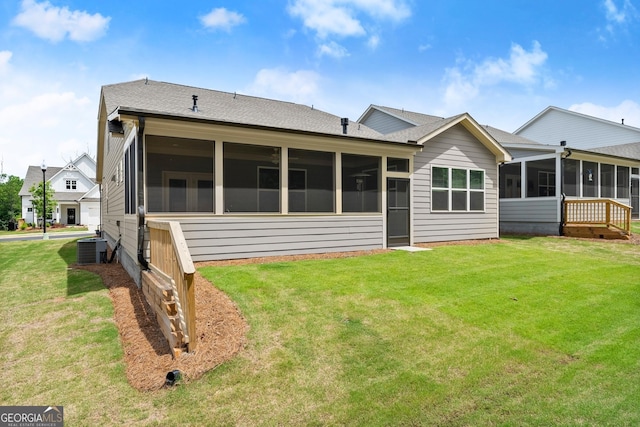 207 Hickory Bluffs Pkwy, Canton, GA 30114 - back of property featuring a sunroom, central air condition unit, a yard, and roof with shingles