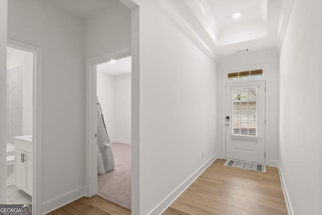 207 Hickory Bluffs Pkwy, Canton, GA 30114 - doorway with light wood-style flooring, a tray ceiling, baseboards, recessed lighting, and crown molding