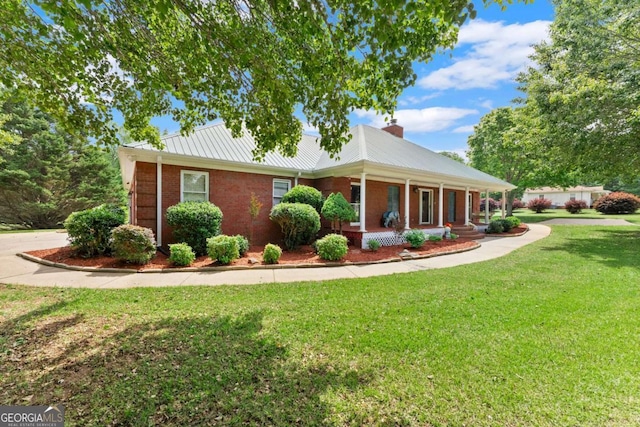 2620 Dr Bramblett Rd, Cumming, GA 30028 - single story home featuring a porch, brick siding, a front yard, a chimney, and metal roof