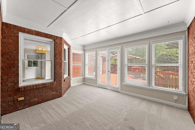 2620 Dr Bramblett Rd, Cumming, GA 30028 - unfurnished sunroom with healthy amount of natural light, carpet, crown molding, brick wall, and baseboards