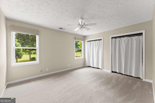 2620 Dr Bramblett Rd, Cumming, GA 30028 - unfurnished bedroom with carpet flooring, baseboards, ceiling fan, a textured ceiling, and multiple closets