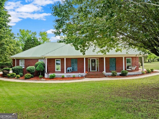 2620 Dr Bramblett Rd, Cumming, GA 30028 - view of front facade featuring a porch, a front lawn, brick siding, and metal roof