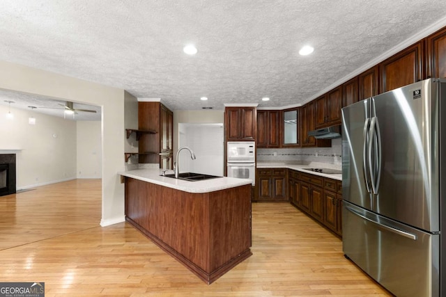 2620 Dr Bramblett Rd, Cumming, GA 30028 - kitchen featuring freestanding refrigerator, a sink, a peninsula, black electric stovetop, and white microwave