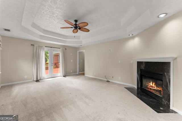 2620 Dr Bramblett Rd, Cumming, GA 30028 - unfurnished living room featuring a raised ceiling, carpet floors, ceiling fan, a fireplace, and a textured ceiling