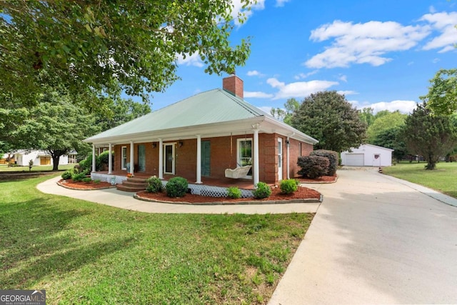2620 Dr Bramblett Rd, Cumming, GA 30028 - view of front of home with covered porch, a chimney, an outbuilding, a front lawn, and brick siding