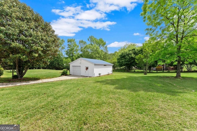2620 Dr Bramblett Rd, Cumming, GA 30028 - view of green lawn with an outbuilding, a garage, driveway, and view of scattered trees