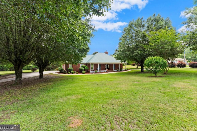 2620 Dr Bramblett Rd, Cumming, GA 30028 - view of grassy yard with driveway and a porch