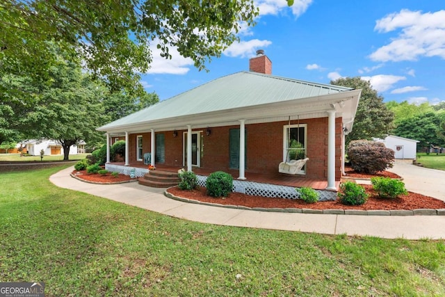 2620 Dr Bramblett Rd, Cumming, GA 30028 - view of front of property featuring a chimney, a front yard, a porch, and brick siding