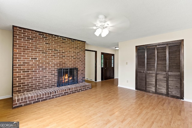121 Stonewood Dr, Toccoa, GA 30577 - unfurnished living room featuring ceiling fan, wood finished floors, a fireplace, and baseboards
