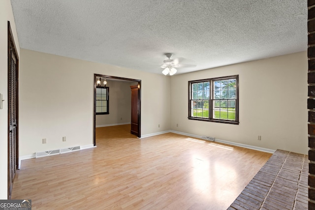121 Stonewood Dr, Toccoa, GA 30577 - unfurnished living room featuring light wood-style flooring, ceiling fan, a textured ceiling, a chandelier, and baseboards