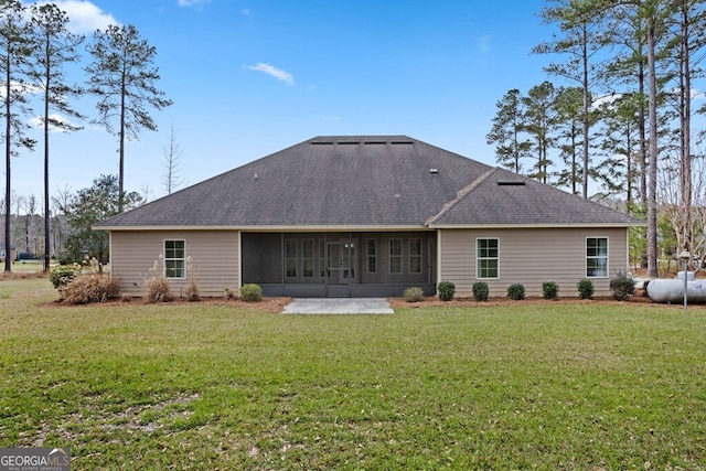 4227 Tillman Blf, Valdosta, GA 31602 - back of property with a shingled roof, a lawn, and a patio