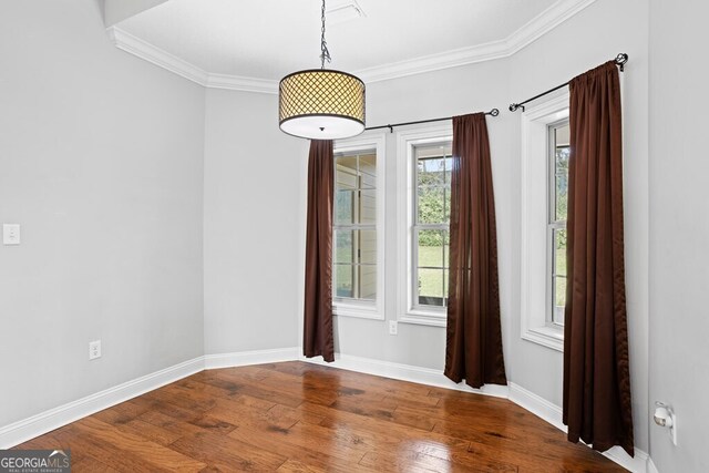 4227 Tillman Blf, Valdosta, GA 31602 - unfurnished dining area with crown molding, wood finished floors, and baseboards