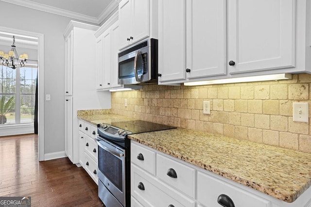 4227 Tillman Blf, Valdosta, GA 31602 - kitchen featuring appliances with stainless steel finishes, a chandelier, dark wood finished floors, white cabinets, and baseboards