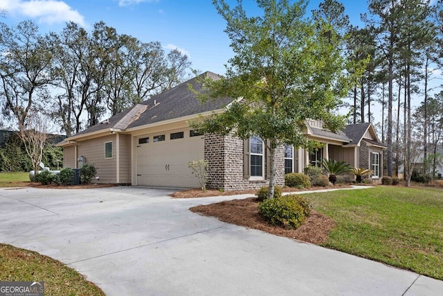 4227 Tillman Blf, Valdosta, GA 31602 - view of side of property with driveway, an attached garage, and a yard
