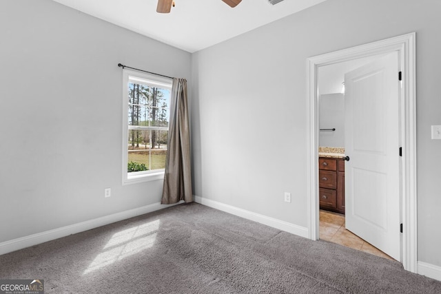 4227 Tillman Blf, Valdosta, GA 31602 - unfurnished bedroom with light colored carpet, baseboards, connected bathroom, and a ceiling fan