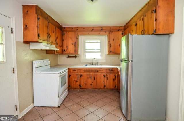 706 Jones Mill Rd, Cartersville, GA 30120 - kitchen featuring freestanding refrigerator, white electric range, under cabinet range hood, a sink, and light countertops
