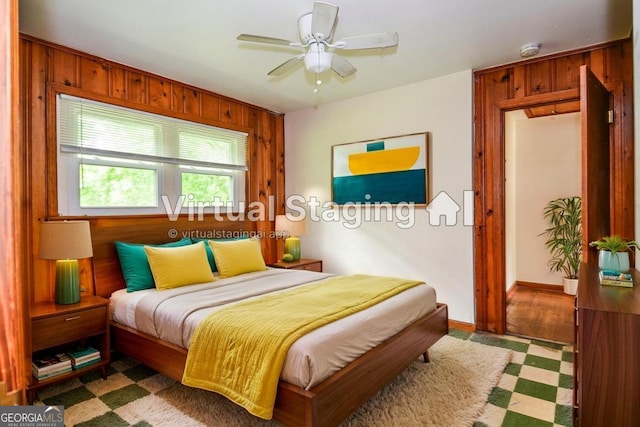 706 Jones Mill Rd, Cartersville, GA 30120 - bedroom featuring wooden walls, a ceiling fan, and baseboards