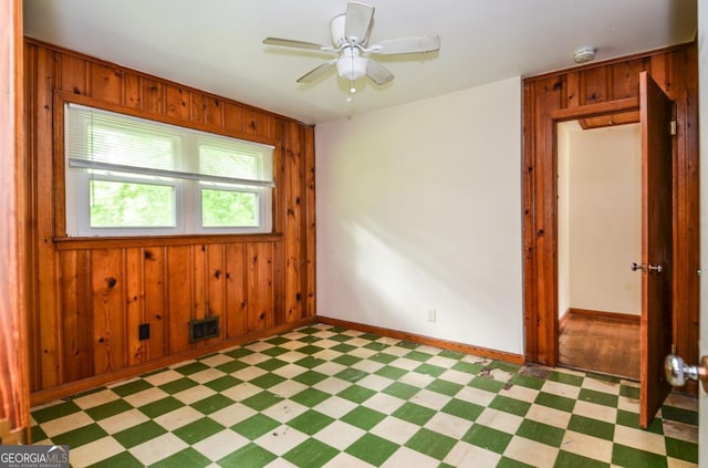 706 Jones Mill Rd, Cartersville, GA 30120 - empty room featuring light floors, wooden walls, a smoke detector, baseboards, and ceiling fan