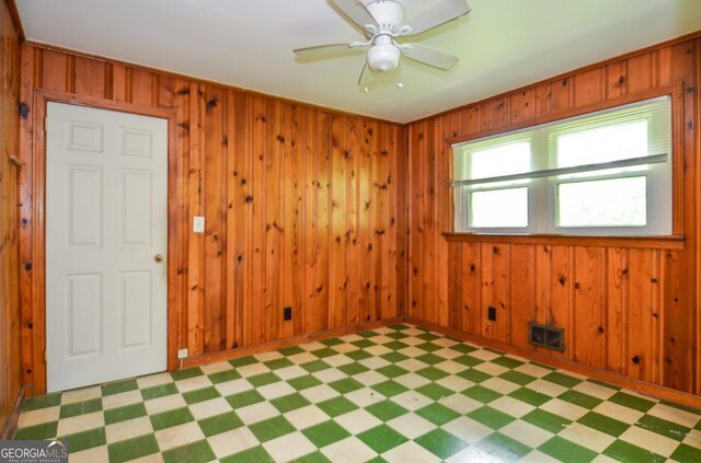 706 Jones Mill Rd, Cartersville, GA 30120 - unfurnished room featuring light floors, wood walls, ceiling fan, and baseboards