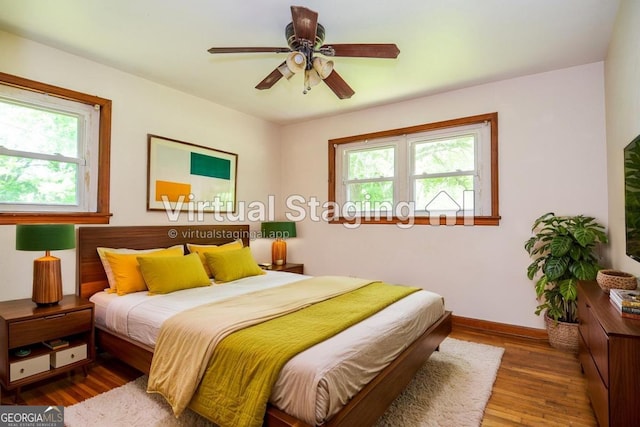 706 Jones Mill Rd, Cartersville, GA 30120 - bedroom featuring baseboards, wood finished floors, and a ceiling fan