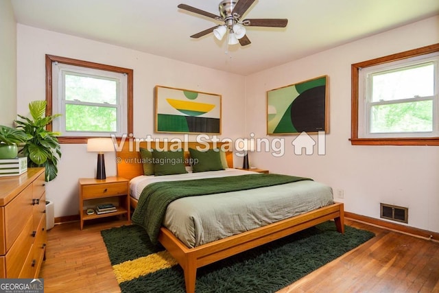 706 Jones Mill Rd, Cartersville, GA 30120 - bedroom featuring multiple windows, baseboards, and light wood-style flooring