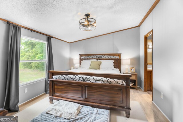 2021 Wyche Cir, Elberton, GA 30635 - bedroom with lofted ceiling, ornamental molding, light wood-style floors, a textured ceiling, and baseboards