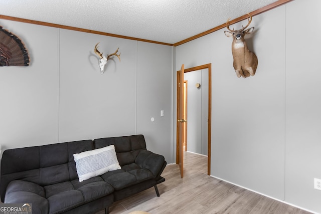 2021 Wyche Cir, Elberton, GA 30635 - living room featuring crown molding, light wood finished floors, and a textured ceiling