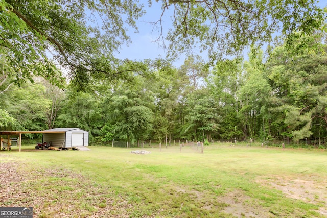 2021 Wyche Cir, Elberton, GA 30635 - view of yard with a garage, a storage unit, an outbuilding, and an outdoor fire pit