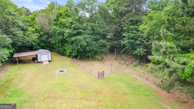 2021 Wyche Cir, Elberton, GA 30635 - view of yard featuring a shed, an outdoor structure, a fire pit, and a garage