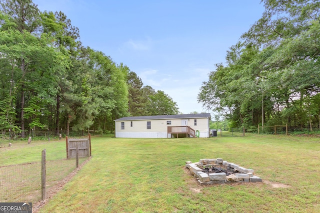 2021 Wyche Cir, Elberton, GA 30635 - view of yard with an outdoor fire pit and a wooden deck