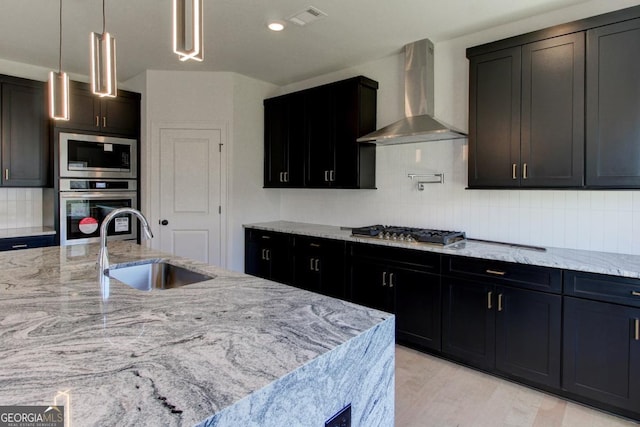 3066 Reserve Ct SW, Conyers, GA 30094 - kitchen with appliances with stainless steel finishes, wall chimney range hood, a sink, backsplash, and light stone counters