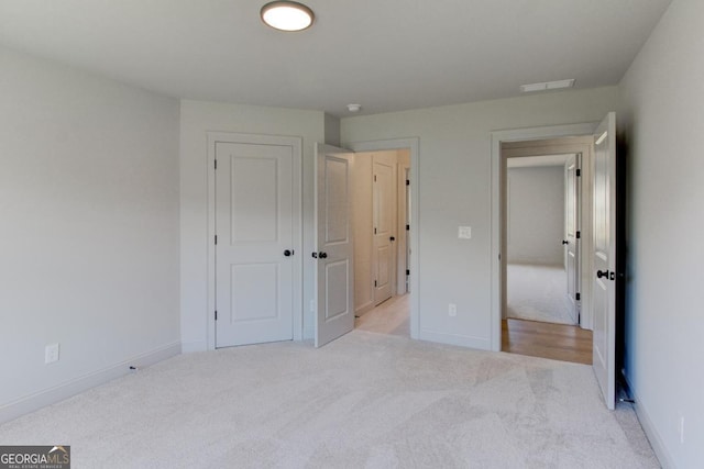 3066 Reserve Ct SW, Conyers, GA 30094 - unfurnished bedroom featuring light colored carpet, baseboards, and a closet