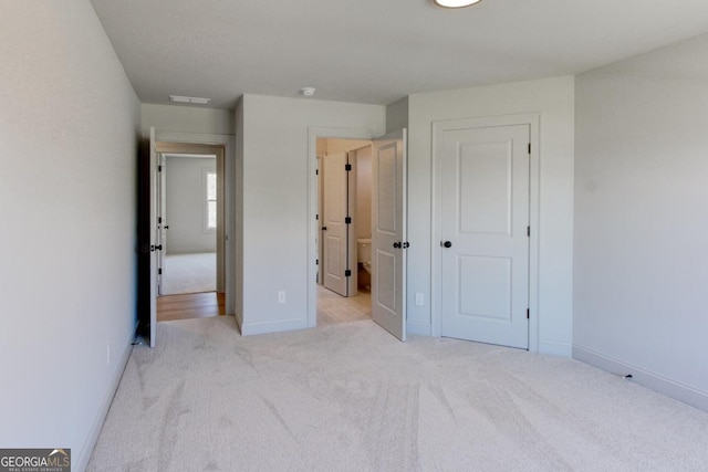3066 Reserve Ct SW, Conyers, GA 30094 - unfurnished bedroom featuring light carpet, baseboards, and a closet
