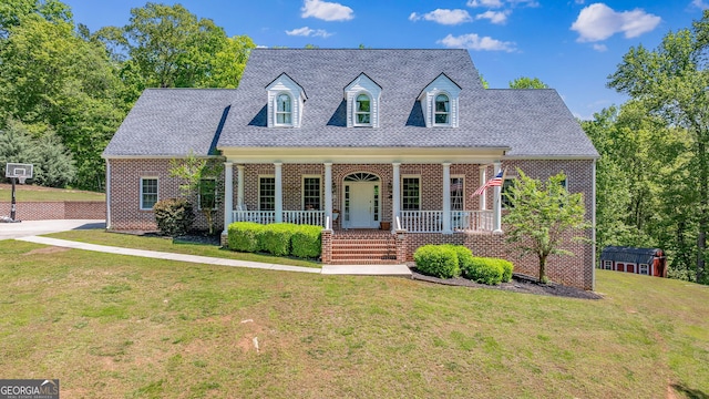 490 Water Wheel Ct, Cornelia, GA 30531 - cape cod home featuring a porch, a storage unit, a front yard, an outdoor structure, and brick siding