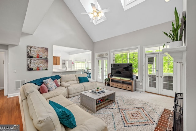 490 Water Wheel Ct, Cornelia, GA 30531 - living area with french doors, high vaulted ceiling, a skylight, a ceiling fan, and baseboards