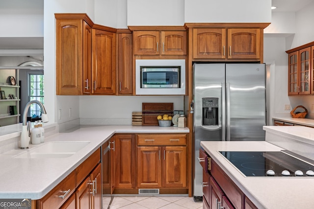 490 Water Wheel Ct, Cornelia, GA 30531 - kitchen with a sink, appliances with stainless steel finishes, brown cabinetry, glass insert cabinets, and light countertops