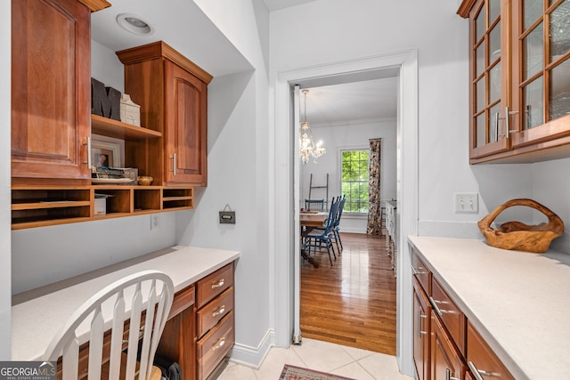 490 Water Wheel Ct, Cornelia, GA 30531 - interior space with a chandelier, light tile patterned floors, built in study area, ornamental molding, and baseboards