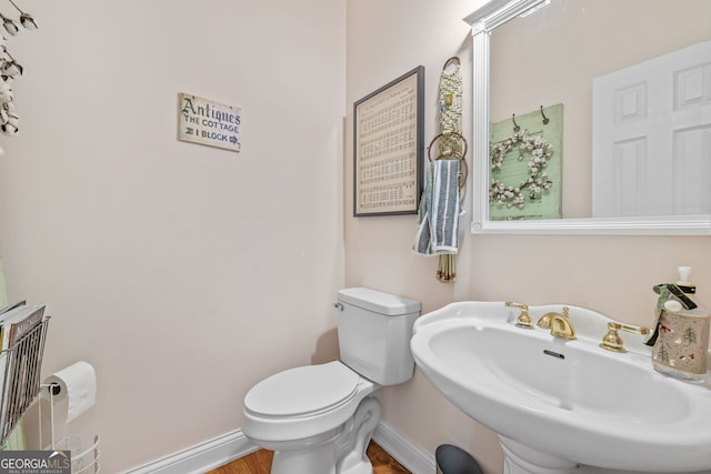 490 Water Wheel Ct, Cornelia, GA 30531 - bathroom with baseboards, toilet, wood finished floors, and a sink