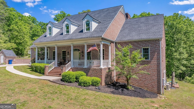 490 Water Wheel Ct, Cornelia, GA 30531 - new england style home with covered porch, brick siding, a front yard, and a shingled roof