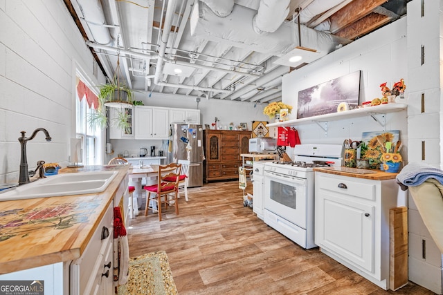 490 Water Wheel Ct, Cornelia, GA 30531 - kitchen with butcher block countertops, white appliances, a sink, and open shelves
