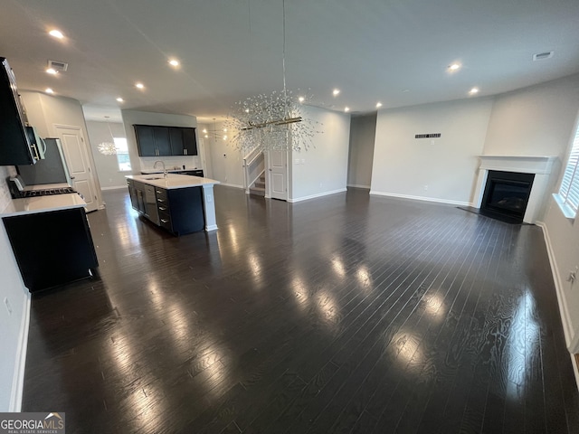 3172 Lowell Rd, Bethlehem, GA 30620 - unfurnished living room with stairs, baseboards, a glass covered fireplace, recessed lighting, and dark wood-style flooring
