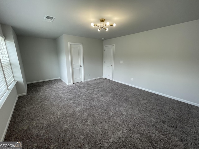 3172 Lowell Rd, Bethlehem, GA 30620 - spare room with baseboards, dark colored carpet, and a chandelier